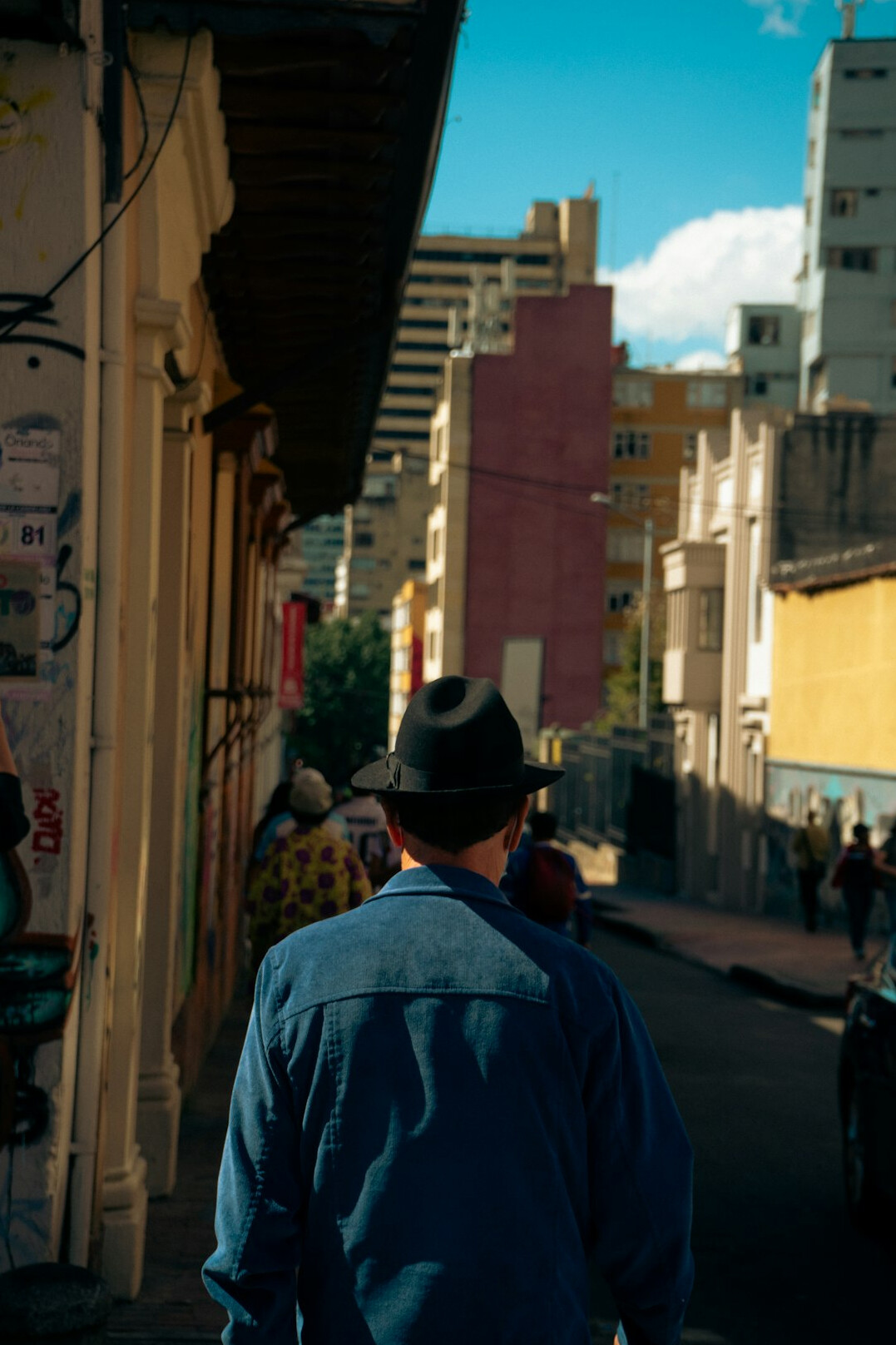 Chilean documentary photographer holding a camera on a city street